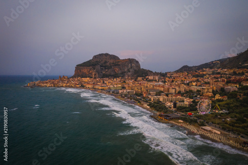Sunset at Cefalu Sicily, old town of Cefalu Sicilia panoramic view at the colorful village. Aerial drone shot, August 2024