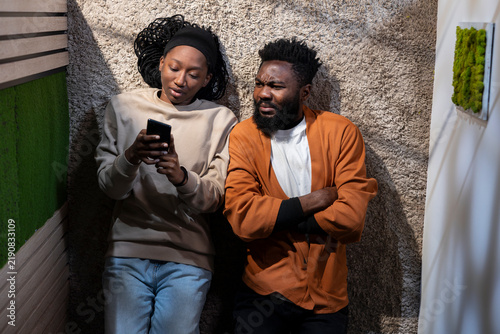 Bild auf Leinwand Top down frustrated couple arguing while lying on a hallway floor at home, showing relationship tension, emotional stress, a heated quarrel, anger and domestic drama between partners