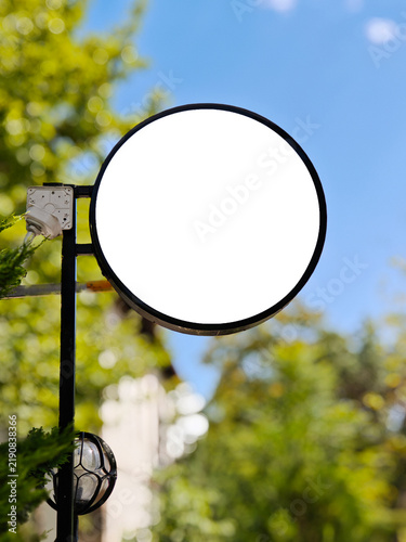 Blank Round Outdoor Shop Signboard Mockup Mounted on Pole with Blue Sky Background