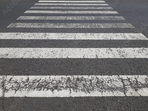 Low Angle View of White Pedestrian Zebra Crossing Lines on Asphalt