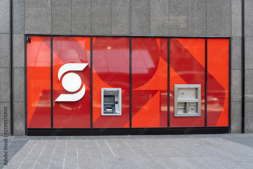 Obraz premium Toronto, Ontario, Canada - September 13, 2026: A Scotiabank exterior wall with an ATM and a night deposit slot behind a red branded glass facade. Toronto, Ontario, Canada. 