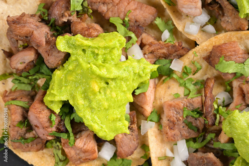 Tasty Mexican street food tacos with meat and fresh guacamole