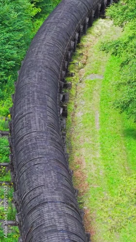 Summer aerial view featuring the 3.4 mile long wooden penstock in Vermont known as The Snake that runs from the Searsburg Dam to a generating station along the Deerfield River with an 8 foot diameter
