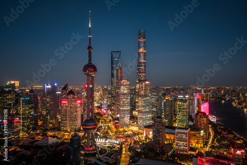 Canvas Print Shanghai CBD skyline illuminated at night, showcasing the iconic and majestic skyscrapers, representing China's immense economic power and future growth