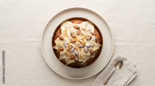 Gourmet white chocolate panettone topped with almonds and candied orange peel
