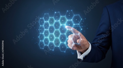 Tapety artystyczne Businessman touching glowing hexagonal network grid, blockchain technology concept, digital connection and data structure visualization, futuristic interface design