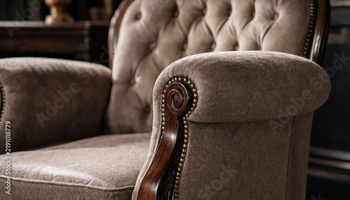 Konstfotografi A close-up view of a classic beige upholstered armchair with tufted backrest, wo