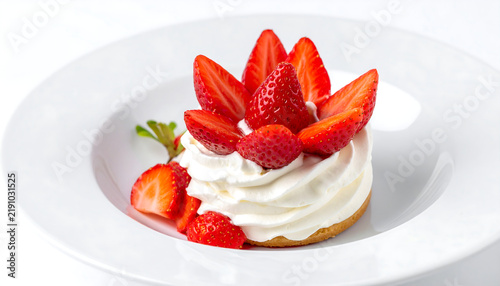 Sweet dessert with strawberries, on white, studio shot