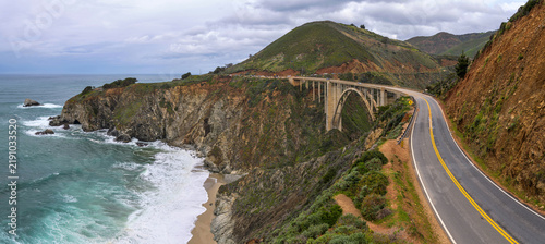 Highway 1 at Bixby Bridge - Panoramic overview of Highway 1 winding along the rocky and scenic coastline at Bixby Bridge on a stormy Spring morning. Big Sur, Monterey, Central Coast of California, USA