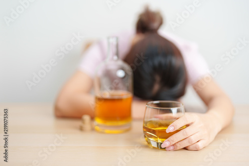 Quadro su tela Stressed woman drinking whisky alone with problem