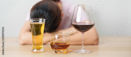 Bild auf Leinwand Stressed woman drinking wine, beer, whiskey or cognac alone with problem
