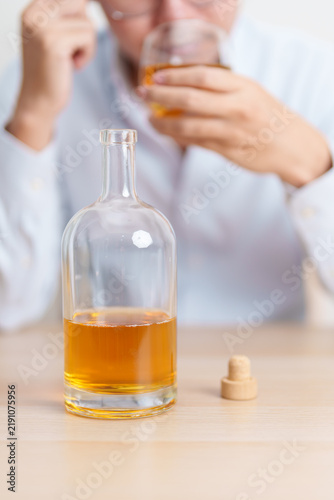 Quadro su tela Stressed man drinking whiskey alone with problem