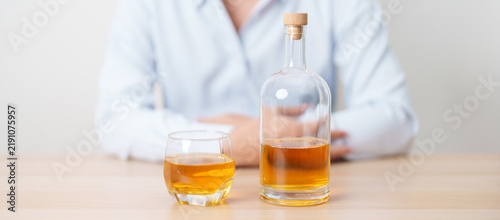 Принти на полотні man with glass of whiskey on table, suffering from alcohol addiction and alcoholism concept