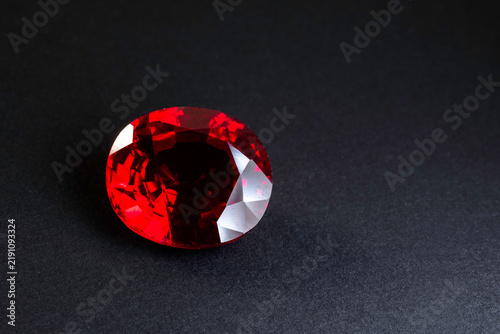 Naklejka Red Ruby gemstone Round Cut isolate on black background, close up shot 