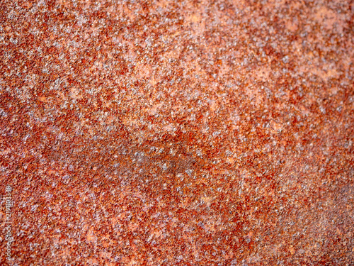 Canvastavla Close-up of rust and corrosion covering a metal sheet, creating a rough orange brown texture and industrial background showing oxidation, weathering and material deterioration
