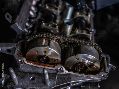 Close up of a car engine timing chain on camshaft gears
