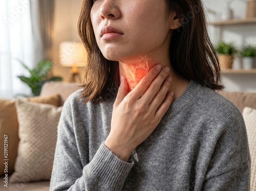 Close-up of woman touching her throat with highlighted anatomical illustration, representing sore throat, irritation.