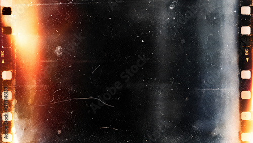Dark cinematic film strip texture with warm orange light leaks, subtle blue haze, film grain, dust, scratches, and visible sprocket holes along the edges.