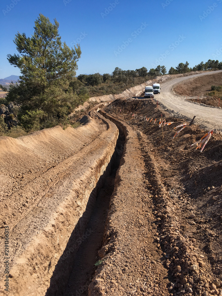 Fototapeta premium Earthworks for a new road construction trench