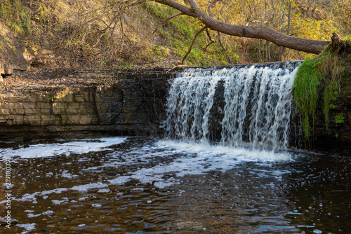 At the Sablinka waterfall on a sunny October morning. Leningrad oblast, Russia