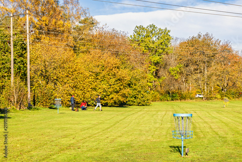 Disc golf players on course in autumn
