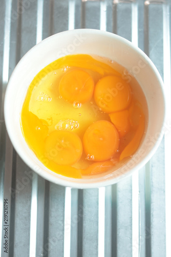 Cracking a raw egg into a bowl, preparing to fry an egg.
