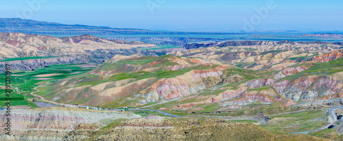 Fotografie Aerial panorama of colorful rolling hills with geological strata and vast plains