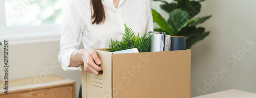 unemployed concept  employee clear her stuff at office to move out after get layoff from company in recession.