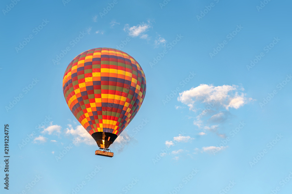 Obraz premium Colorful hot air balloon floating against clear blue Cappadocia sky