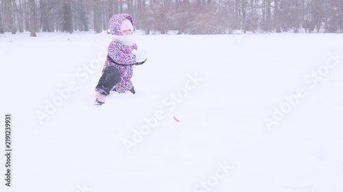 Toddler cold weather. Child enjoying snow game with parent. Joyful childhood concept.