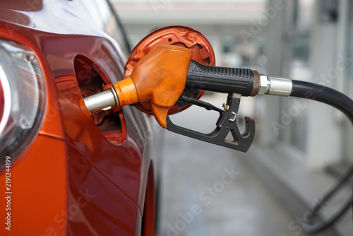 Canvastavla Orange benzene gas pump nozzle filling up red sport car tank