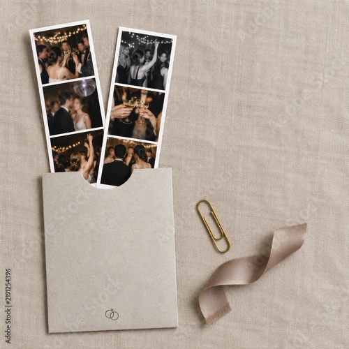Blank wedding photo booth strip sleeve mockup with ribbon on linen background