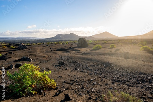 Large round volcanic stone Bomba volcánica Gude, volcanic landscape with lava fields, Parque Natural de Los Volcanes, Lanzarote, Canary Islands, Spain