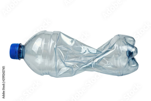 Empty crushed transparent plastic water bottle with a blue cap lying horizontally on a white surface isolated on a transparent background