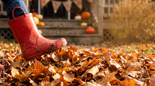 A Child's Red Boot Treads Through a Pile of Colorful Autumn Leaves on a Crisp Fall Day, Evoking the Joy and Playfulness of Seasonal Outdoor Activities