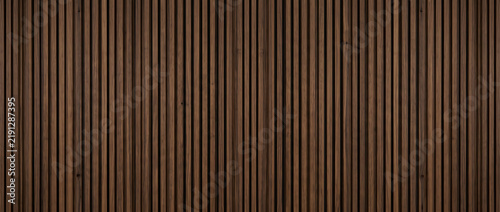 Fotografie Dark wood slat panel texture background showing walnut timber batten wall strips