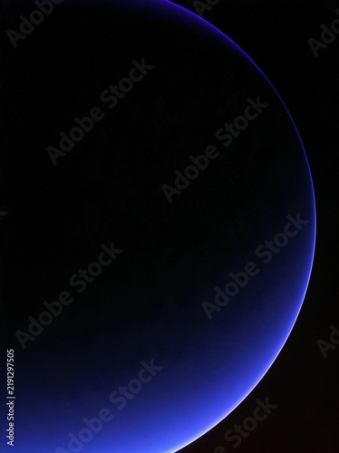 Close-up of a blue planet with a black background. the planet appears to be in motion, as if it is moving towards the right side of the image.