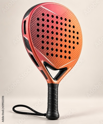 Vibrant gradient padel racket in striking orange and red hues, featuring a perforated face and black handle, standing vertically against a light gray backdrop.