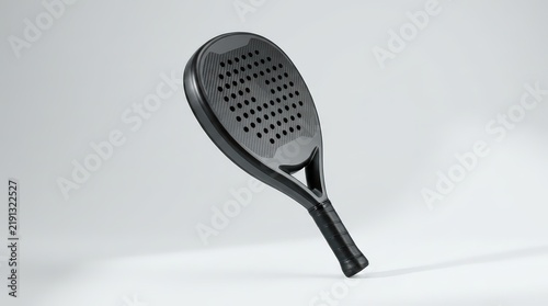 Simple and sleek black padel racket mockup, positioned dynamically at an angle on a light gray surface, showcasing its form and potential for customization.