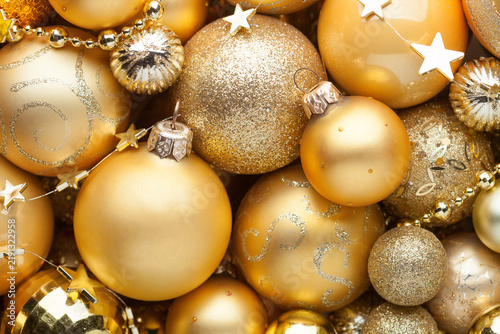 Monochrome  backgraund  of  golden Christmas  ornaments different sizes, shades and textures. Flay lay