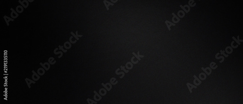 A smooth dark black background with a subtle fine grain texture throughout
