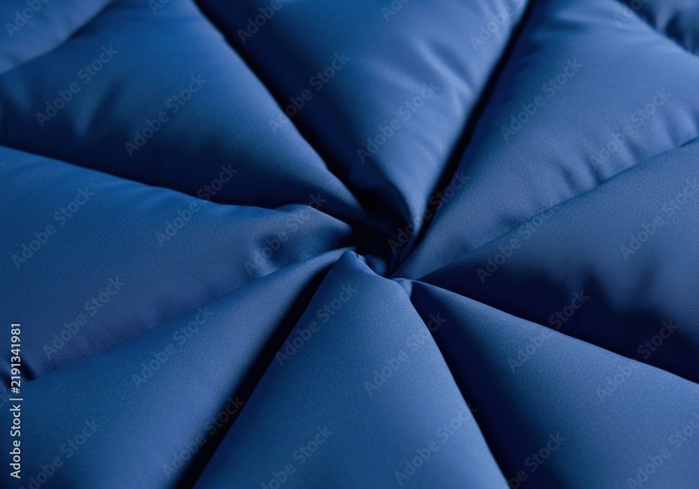 Obraz premium Abstract dark blue quilted fabric texture with geometric pattern.