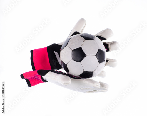 Soccer ball and goalkeeper gloves isolated on a white background.