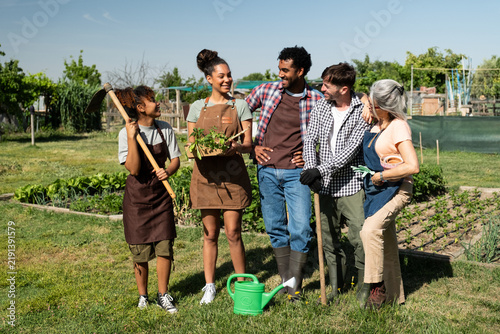Multi ethnic group friends enjoying working together in a sustainable urban garden