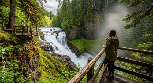 Hiker Admiring Misty Forest Waterfall from Wooden Viewpoint.