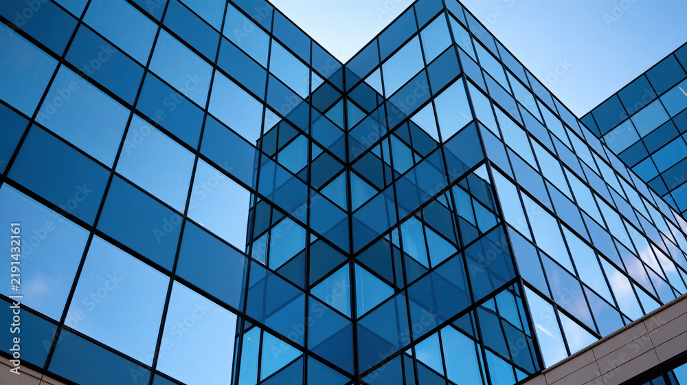 Obraz premium Blue glass building modern office building reflective facade geometric architecture urban exterior corporate architecture skyscraper glass wall blue sky business district