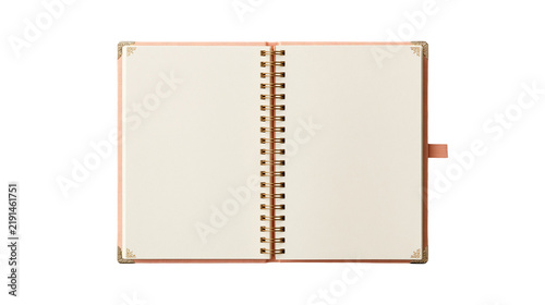 Open spiral bound notebook with cream pages and decorative gold corner accents