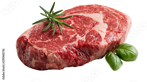 Obraz na płótnie Raw ribeye beef steak with fresh rosemary sprig and green basil leaves