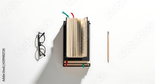 Study desk with book glasses pencil.