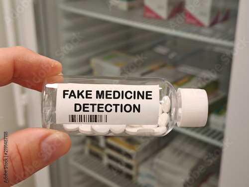 FAKE MEDICINE DETECTION counterfeit medicine topic for drug authenticity safety and supply chain security bottle with tablets in pharmacy